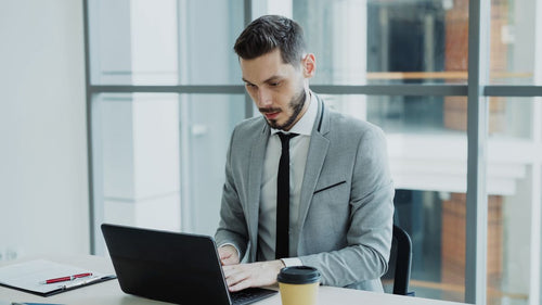 Professional working on a laptop in an office